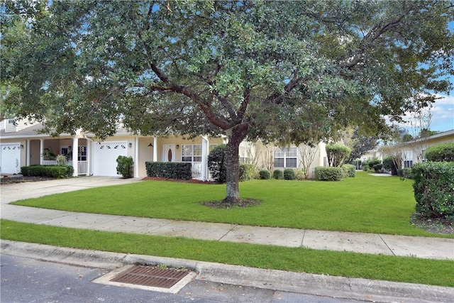 view of property hidden behind natural elements with a front yard and a garage