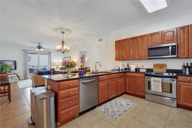 760 Ocean Blvd Unit 402, Saint Simons Island, GA 31522 - kitchen featuring stainless steel appliances, a peninsula, a sink, a chandelier, and light tile patterned flooring