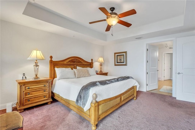 760 Ocean Blvd Unit 402, Saint Simons Island, GA 31522 - bedroom with a tray ceiling, light colored carpet, and a ceiling fan