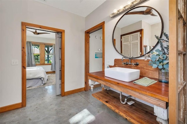 bathroom with ceiling fan, concrete flooring, and sink