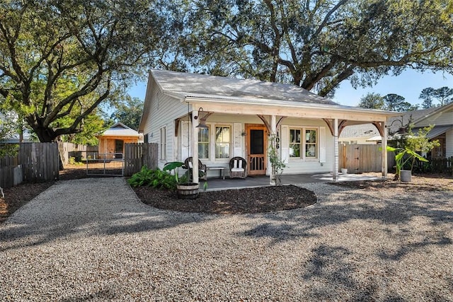 rear view of property featuring a porch