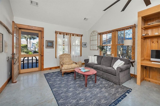 living room with a textured ceiling, ceiling fan, and vaulted ceiling