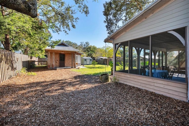 view of yard with a storage shed and a sunroom