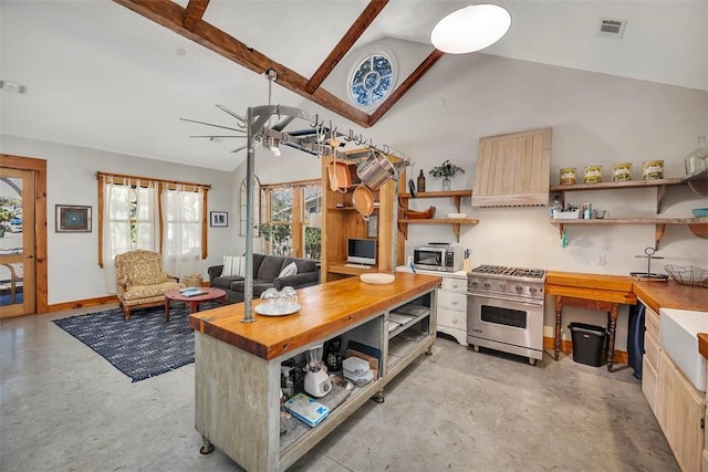 kitchen featuring a center island, ceiling fan, butcher block countertops, custom range hood, and stainless steel appliances