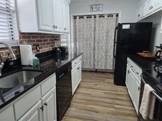 kitchen with tasteful backsplash, sink, black appliances, light hardwood / wood-style flooring, and white cabinetry