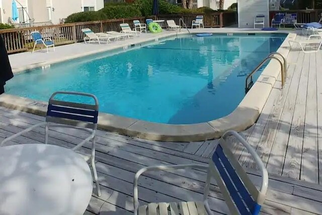 view of swimming pool featuring a deck