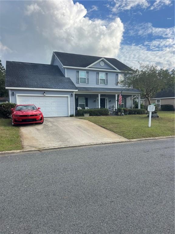 114 Shell Pointe Dr, Brunswick, GA 31525 - view of front facade with a front yard, a garage, and covered porch