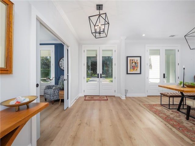 904 Champney, Saint Simons Island, GA 31522 - foyer with french doors, ornamental molding, light wood-type flooring, a chandelier, and recessed lighting