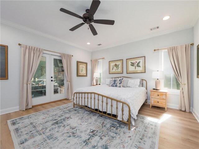 904 Champney, Saint Simons Island, GA 31522 - bedroom with french doors, multiple windows, access to outside, ornamental molding, and wood finished floors