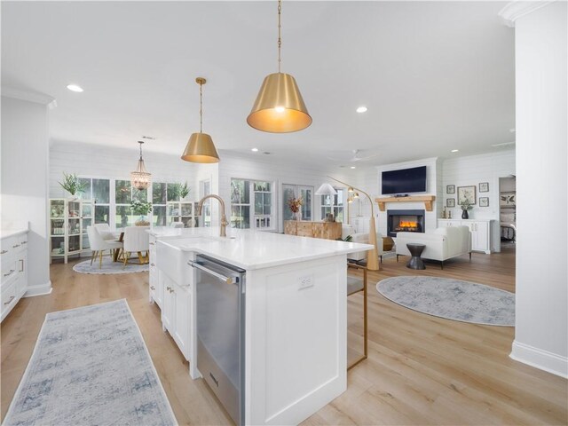 904 Champney, Saint Simons Island, GA 31522 - kitchen featuring dishwasher, a lit fireplace, white cabinetry, light countertops, and recessed lighting