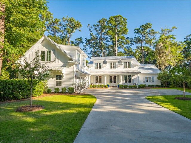 904 Champney, Saint Simons Island, GA 31522 - view of front of home featuring board and batten siding, driveway, and a front yard