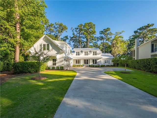 904 Champney, Saint Simons Island, GA 31522 - view of front of house with board and batten siding and a front lawn