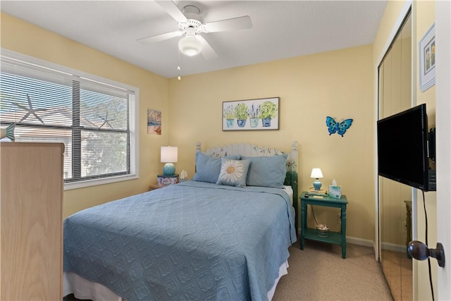 carpeted bedroom with ceiling fan