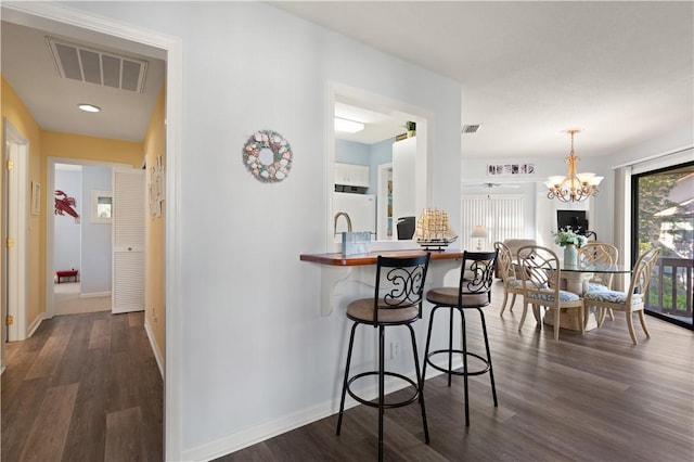 interior space featuring a notable chandelier and dark hardwood / wood-style flooring