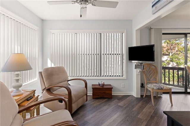 sitting room featuring ceiling fan, dark hardwood / wood-style flooring, and a healthy amount of sunlight