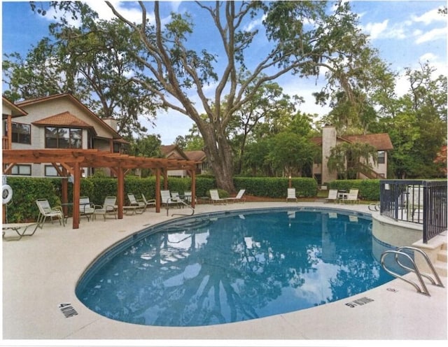 view of swimming pool featuring a patio area and a pergola