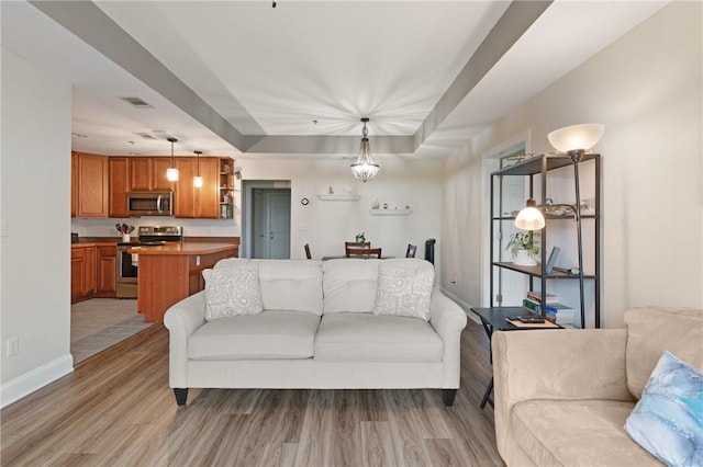 living area with light wood finished floors and baseboards