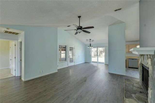 unfurnished living room featuring ceiling fan, dark hardwood / wood-style flooring, vaulted ceiling, and a textured ceiling