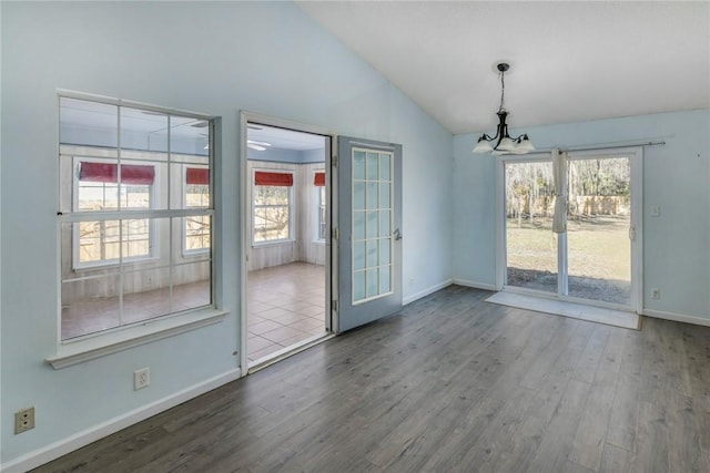 interior space featuring a notable chandelier, french doors, vaulted ceiling, and hardwood / wood-style flooring