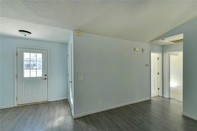 foyer featuring a textured ceiling, vaulted ceiling, and wood-type flooring