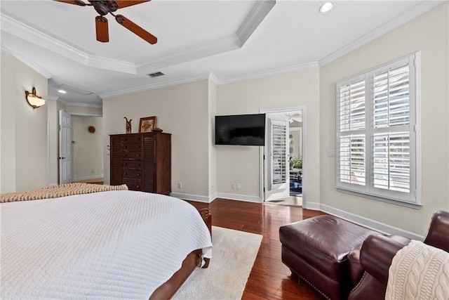 bedroom featuring crown molding, ceiling fan, dark hardwood / wood-style flooring, and a tray ceiling