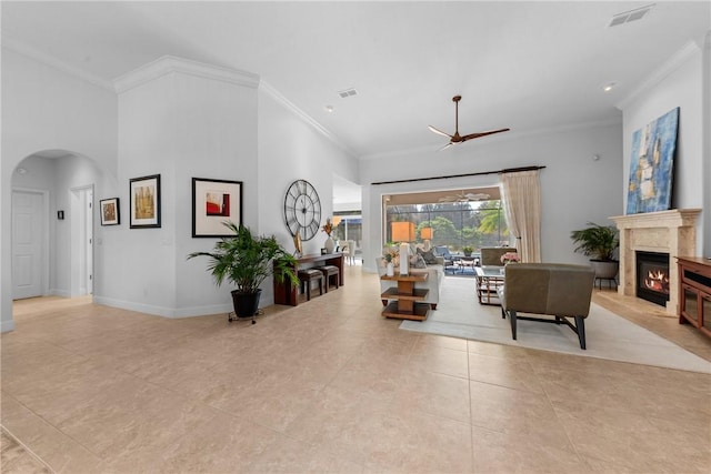 tiled living room featuring crown molding and a towering ceiling