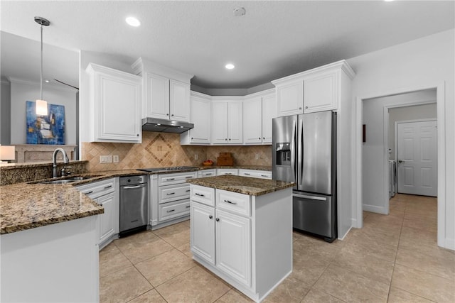 kitchen featuring stainless steel refrigerator with ice dispenser, sink, white cabinetry, hanging light fixtures, and a kitchen island