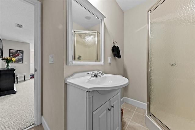 bathroom with tile patterned floors, vanity, and an enclosed shower