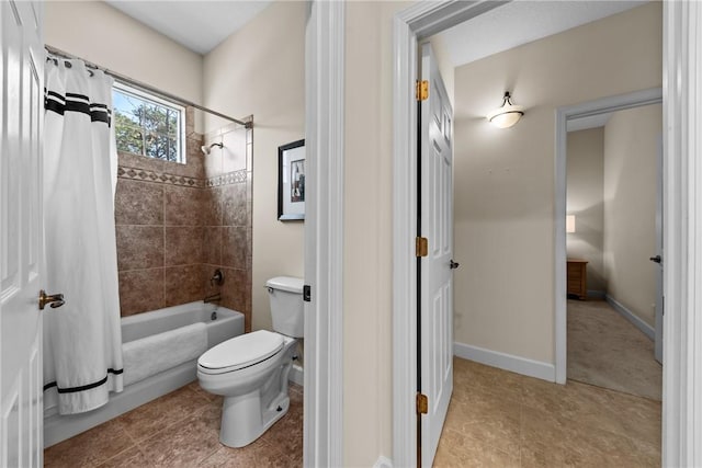 bathroom with tile patterned floors, toilet, and shower / bath combo