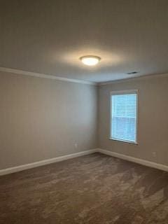 carpeted spare room featuring ornamental molding