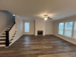 unfurnished living room with crown molding, ceiling fan, and dark hardwood / wood-style floors