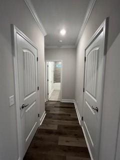 hallway featuring dark wood-type flooring and ornamental molding