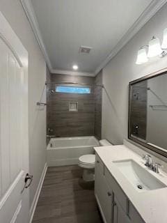 full bathroom featuring vanity, crown molding, tiled shower / bath, hardwood / wood-style flooring, and toilet