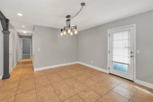 unfurnished dining area featuring light tile patterned flooring and a chandelier