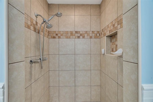 interior details featuring tiled shower