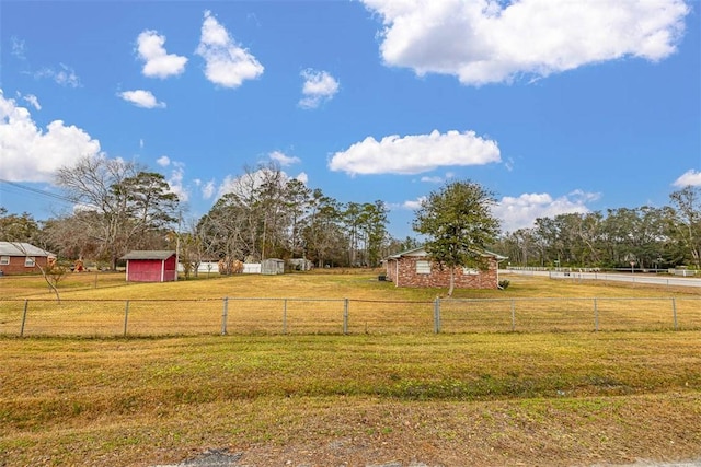 view of yard with a rural view and a storage unit