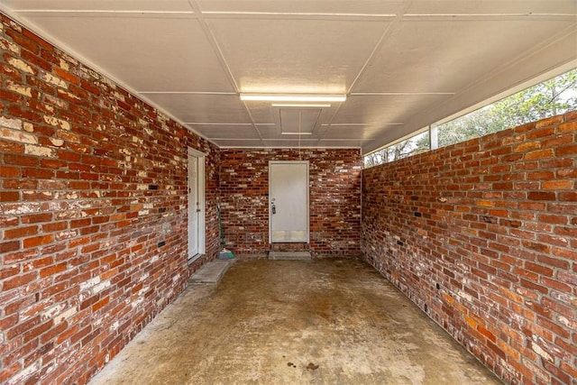 exterior space featuring brick wall