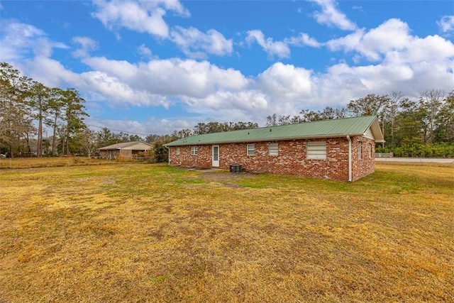 back of property featuring a lawn