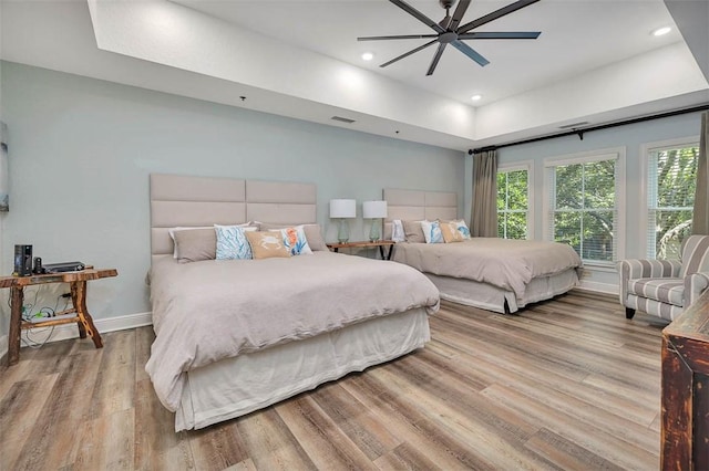 150 Salt Air Dr Unit 202, Saint Simons Island, GA 31522 - bedroom featuring a tray ceiling, wood finished floors, a ceiling fan, and recessed lighting