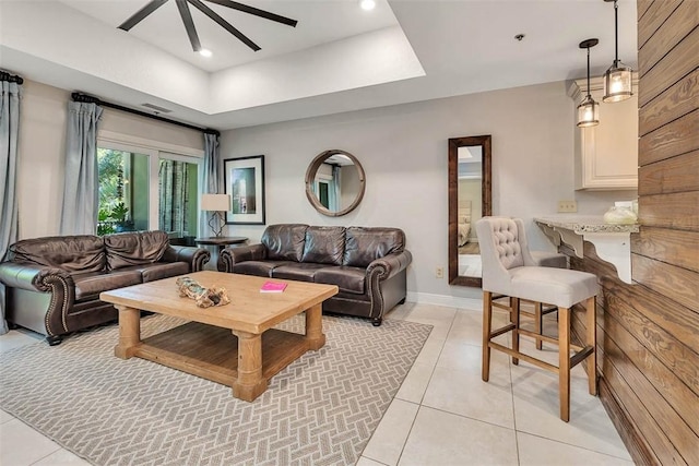 150 Salt Air Dr Unit 202, Saint Simons Island, GA 31522 - living area featuring light tile patterned floors, ceiling fan, and a raised ceiling