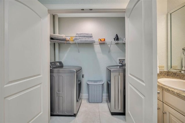 150 Salt Air Dr Unit 202, Saint Simons Island, GA 31522 - laundry area with washer and clothes dryer and light tile patterned floors