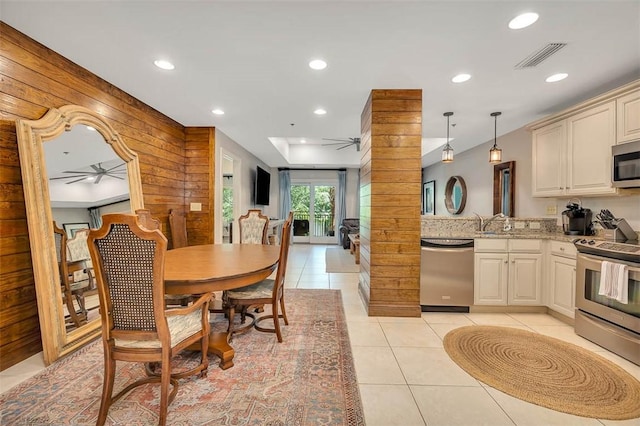 150 Salt Air Dr Unit 202, Saint Simons Island, GA 31522 - kitchen with stainless steel appliances, a ceiling fan, wood walls, recessed lighting, and light tile patterned flooring