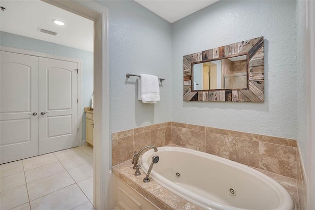 150 Salt Air Dr Unit 202, Saint Simons Island, GA 31522 - full bathroom with a tub with jets, vanity, a textured wall, and tile patterned flooring