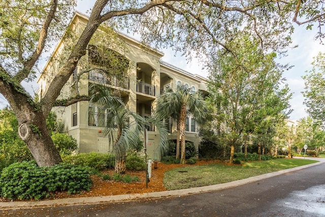 150 Salt Air Dr Unit 202, Saint Simons Island, GA 31522 - view of front of house featuring a balcony and stucco siding