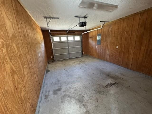 garage with electric panel, a garage door opener, and wooden walls