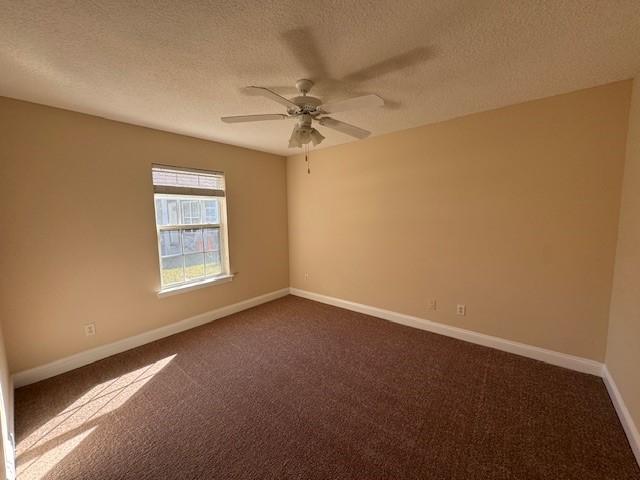 unfurnished room featuring carpet, ceiling fan, and a textured ceiling