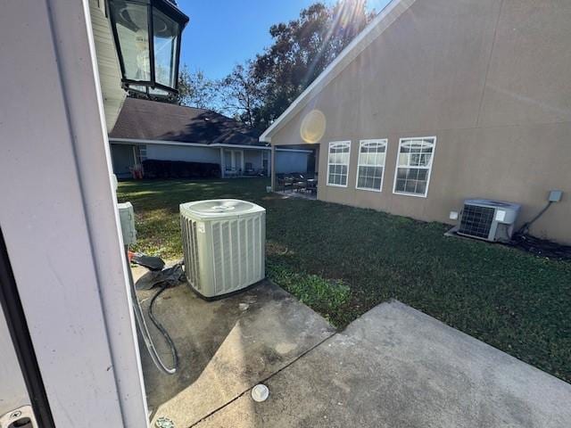 view of yard featuring central AC and a patio