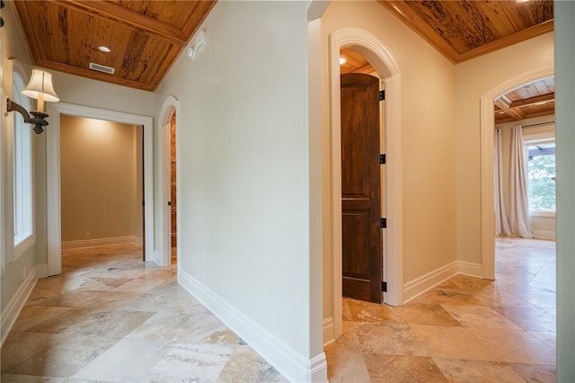 178 Hampton Point Dr, Saint Simons Island, GA 31522 - corridor featuring a wood ceiling with exposed beams, arched walkways, and stone tile floors