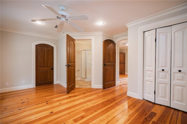 178 Hampton Point Dr, Saint Simons Island, GA 31522 - unfurnished bedroom featuring arched walkways, ornamental molding, a closet, light wood-style floors, and recessed lighting
