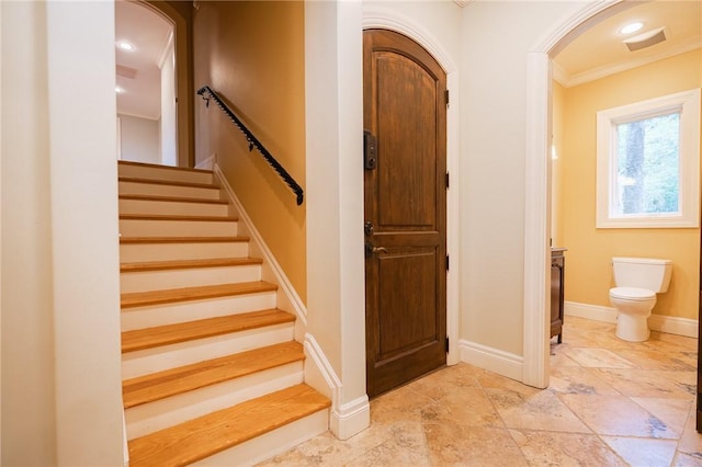 178 Hampton Point Dr, Saint Simons Island, GA 31522 - stairs with crown molding, stone tile flooring, and arched walkways
